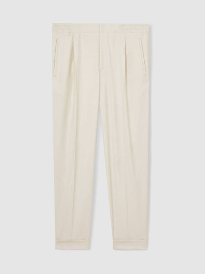 Relaxed-Fit Pleated Tapered Trousers in Ecru | Reiss Men Signature