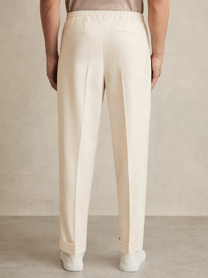 Relaxed-Fit Pleated Tapered Trousers in Ecru | Reiss Men Signature