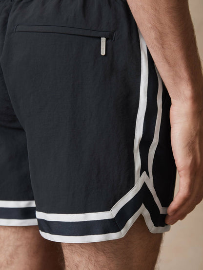 | Ché Stripe-Trim Swim Shorts in Navy | Reiss Men Premium