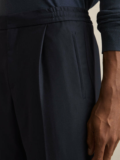 Relaxed-Fit Pleated Tapered Trousers in Navy | Reiss Men Signature