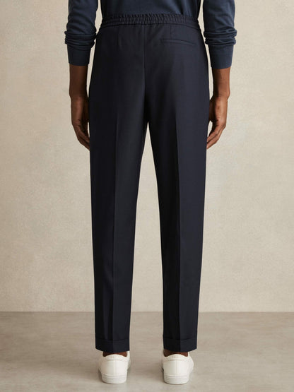 Relaxed-Fit Pleated Tapered Trousers in Navy | Reiss Men Signature